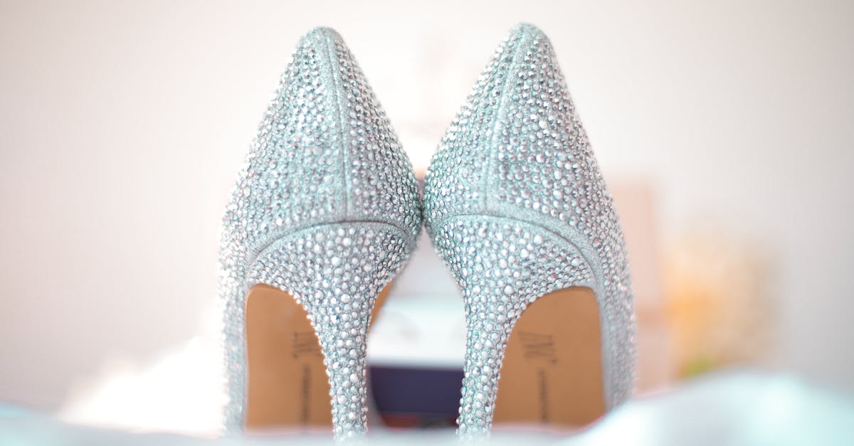 Diamond Jubilee events listing - Stylish wedding high heels decorated with shiny silver rhinestones placed on white fabric