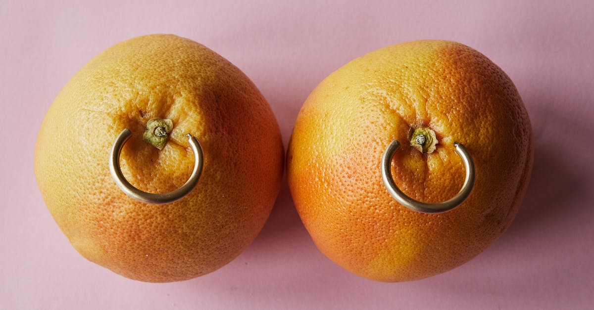 Did not declare jewelry from Aruba - Fresh mandarins with earrings placed on pink surface