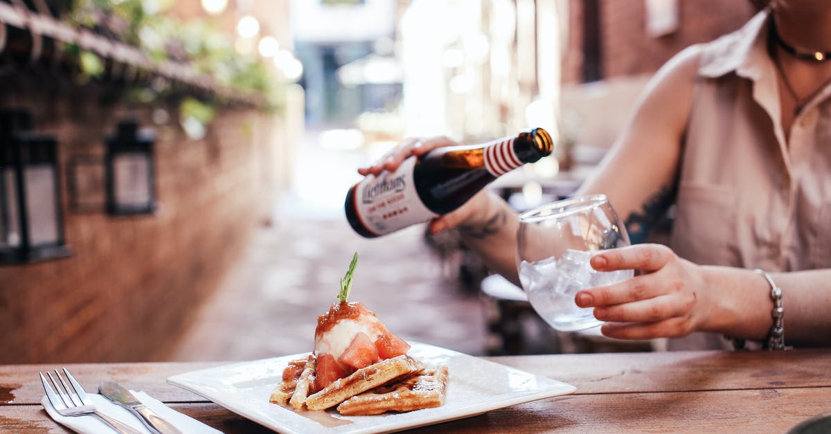 Did TGVs have restaurant-style dining? - Person Pouring Wine on Brown Wooden Table