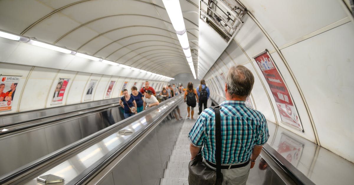 Difference between Frankfurt Flughafen Fernbahnhof and Flughafen Regionalbahnhof? Which station should I go to for Frankfurt Terminal 1? - Man Wearing Blue Plaid Shirt Standing on Subway Escalator Difference between Frankfurt Flughafen Fernbahnhof and Flughafen Regionalbahnhof? Which station should I go to for Frankfurt Terminal 1? - Man Wearing Blue Plaid Shirt Standing on Subway Escalator