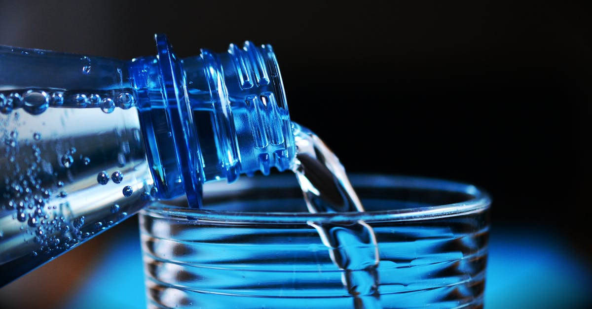 Difference in mineral bottled water price between European countries [closed] - Close-up of Bottle Pouring Water on Glass