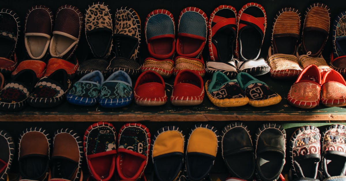 different arrival date in turkey than visa is for - Shelves with assorted small bright handmade Turkish boots for kids selling in small local workshop