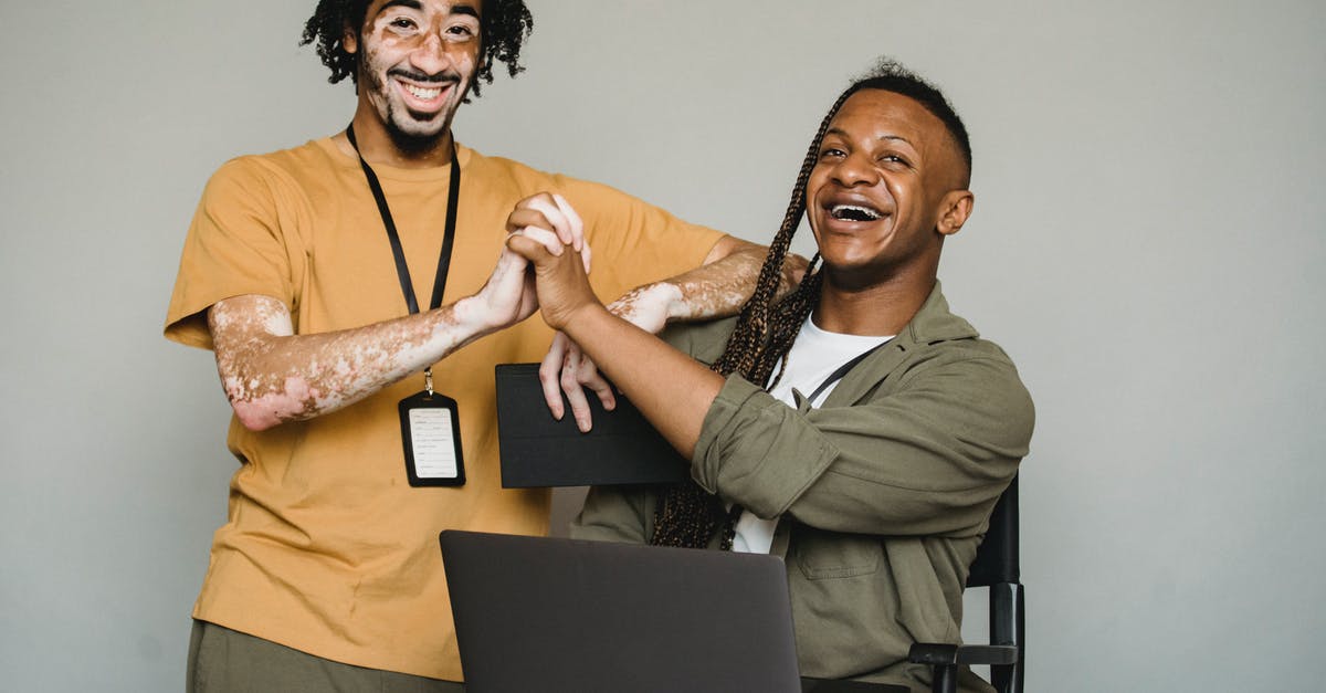 Different name in Passport and Residence Permit - Smiling black coworkers holding hands in studio