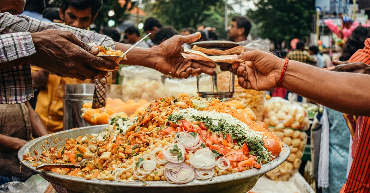 Difficulties with or reprimands for passing COVID hotspot? - Man in Red and White Stripe Long Sleeve Shirt Holding Stainless Steel Tray With Food