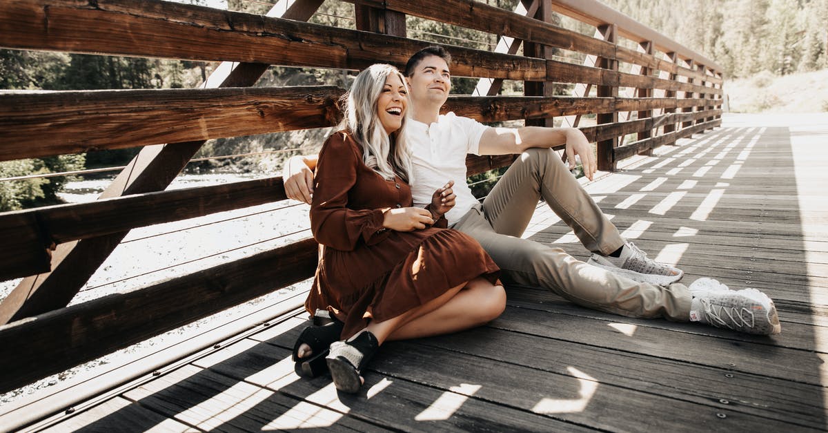 Dingo fence - how to visit? - Woman in Brown Coat Sitting on Wooden Bridge