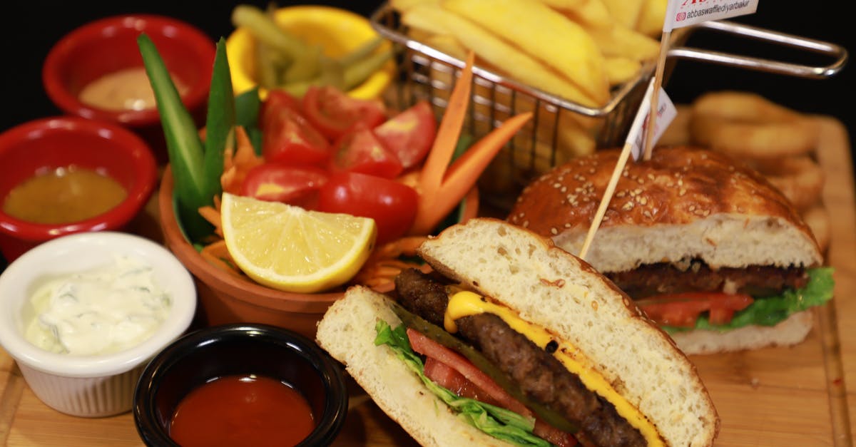 Dinner before claiming baggage - Burger With Fries and Tomato on Brown Wooden Table