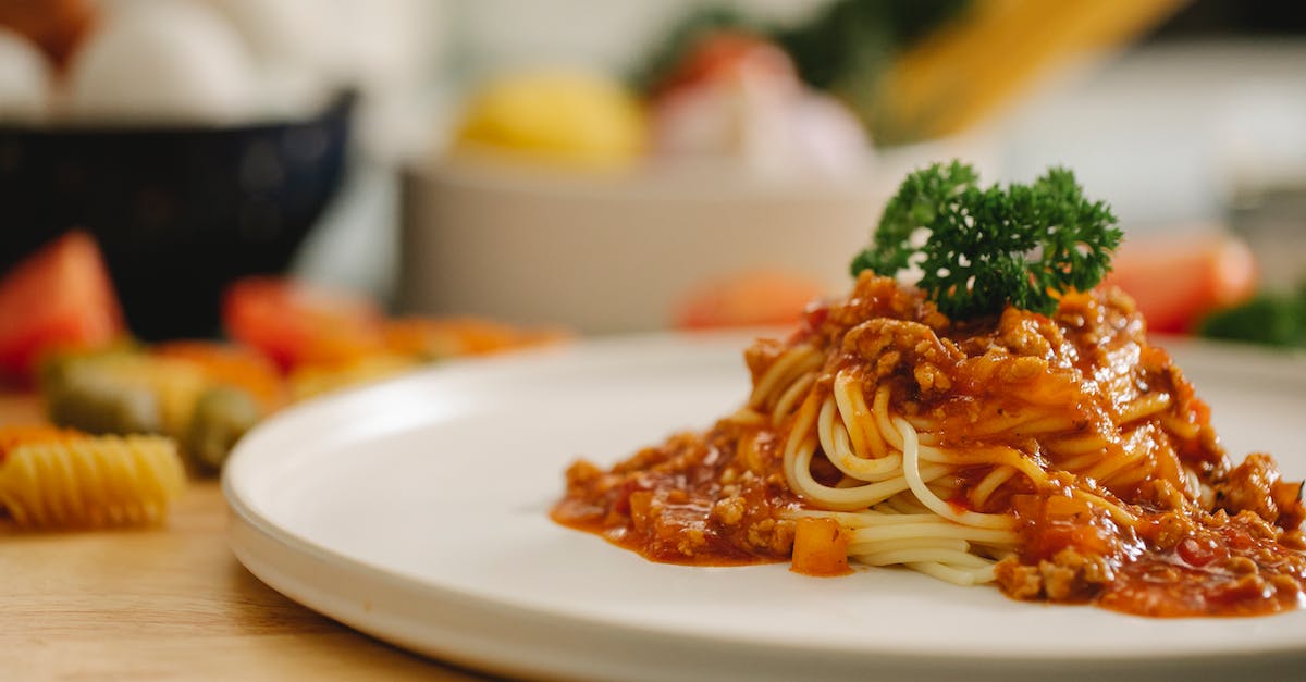 Dinner service out of Los Angeles on Amtrak Southwest Chief - Delicious yummy spaghetti pasta with Bolognese sauce garnished with parsley and served on table in light kitchen