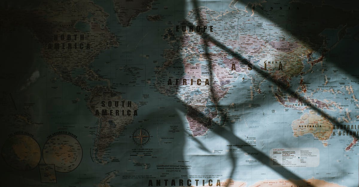 Direction to go to Australia -- where does it change? - Old world map placed on wall