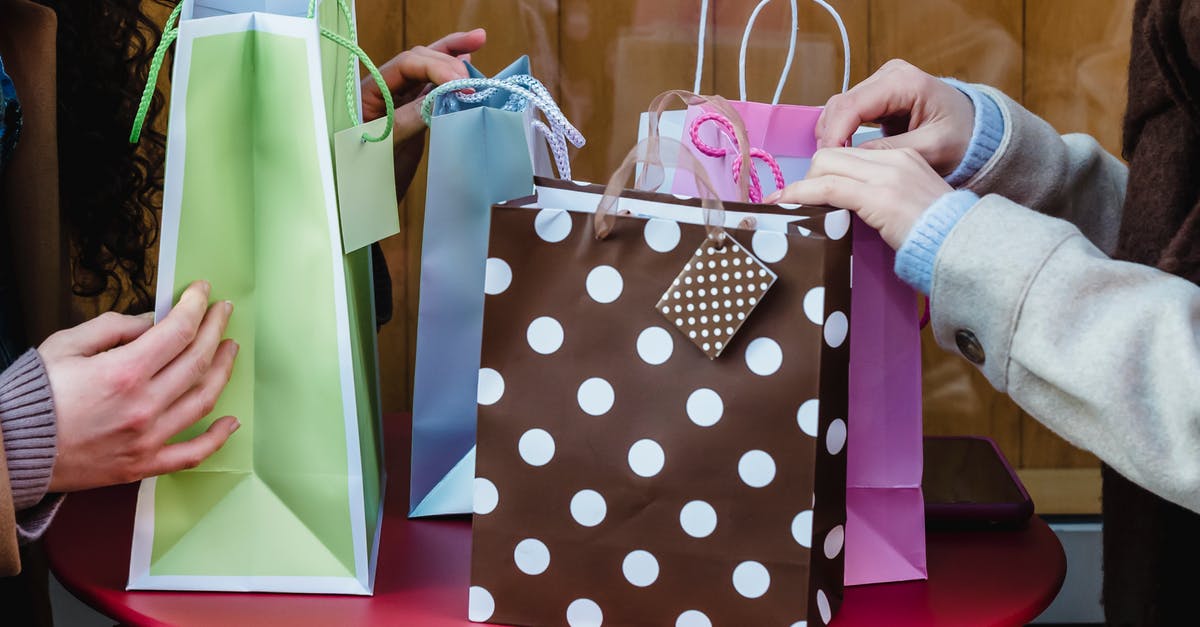 Do airlines show different seats to different customers during online check-in? - Side view of crop anonymous female friends sitting at table with various colorful gift bags bought for occasion