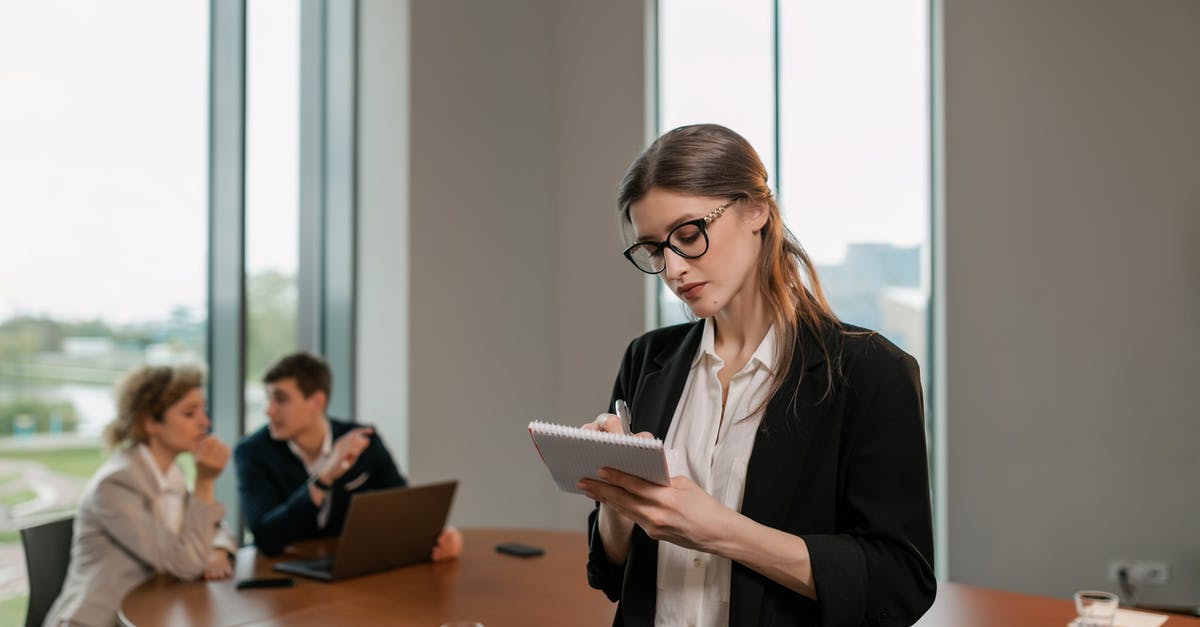 Do American cellphones work in Europe? - Woman in Black Blazer Writing on Notebook