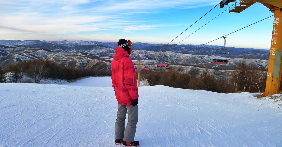 Do any of the ski resorts near Zurich offer late season (May) skiing? - Man Wearing Red Jacket