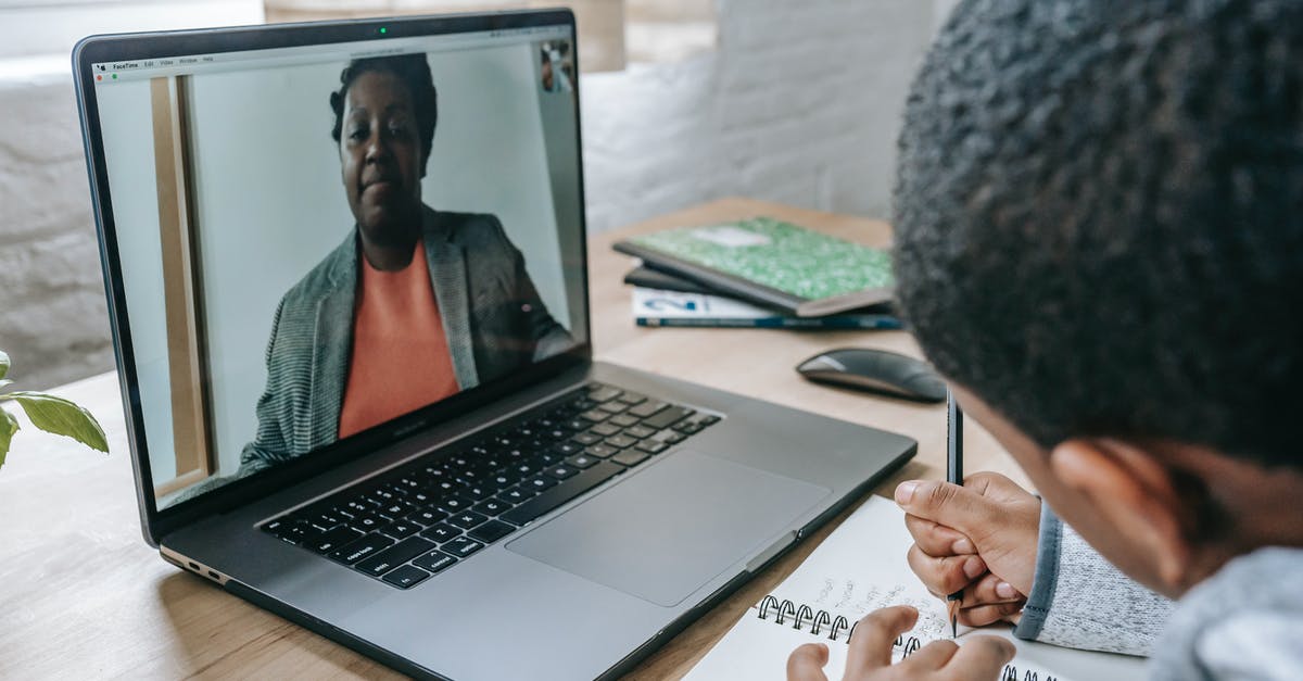 Do children need a COVID test to enter Germany? - Side view of crop anonymous African American boy having test while teacher explaining information online on laptop