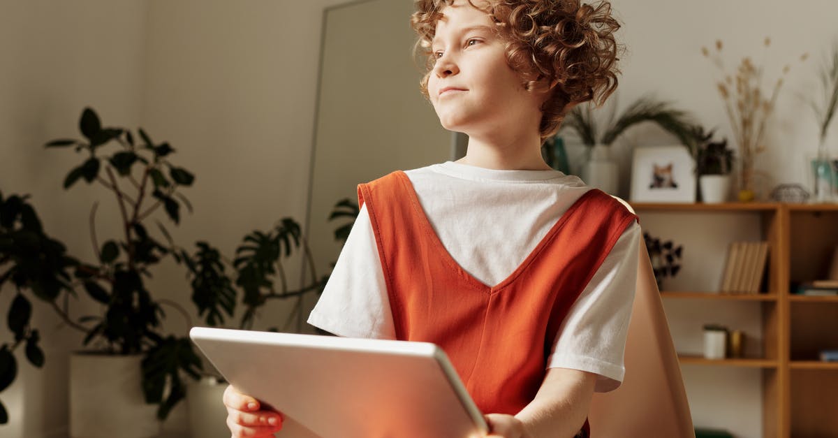 Do children stay free in hotels/accommodation in South Africa? - Photo of Child Sitting on Chair While Holding Tablet