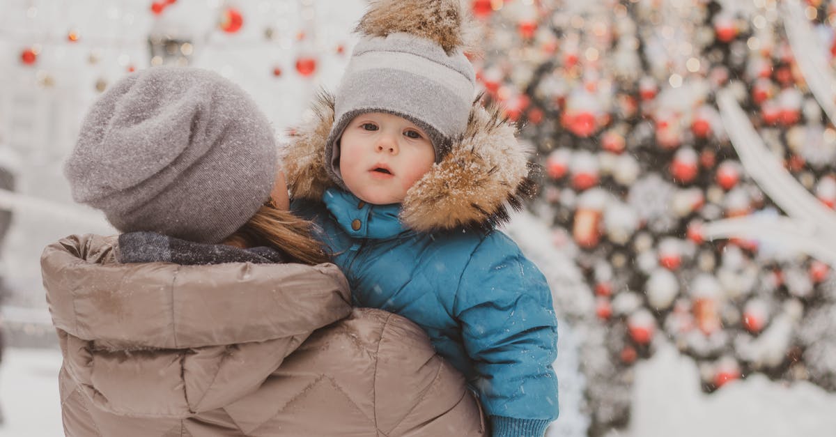 Do I have to carry snow chains in Europe? - A Mother Carrying Her Daughter Out in the Snow