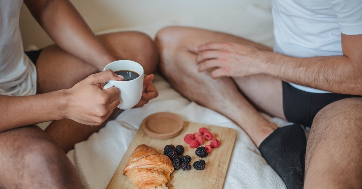 Do I have to declare my fruits flying into the EU? - Two Unrecognizable Men Sitting on Bed and Having Breakfast