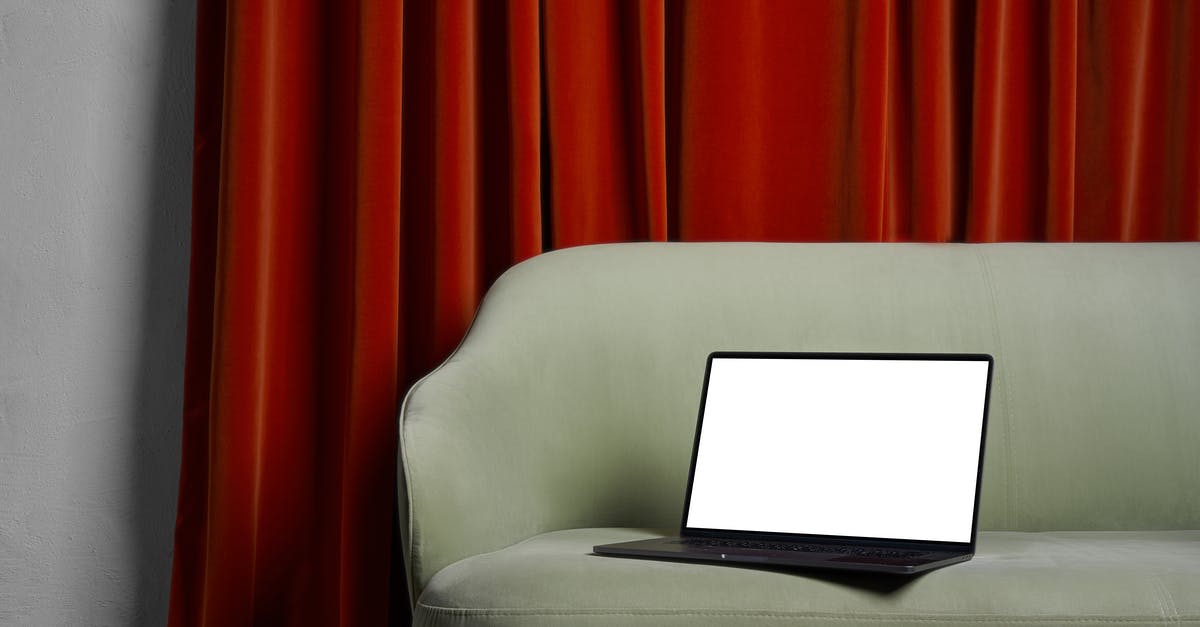 Do I have to declare my new laptop when leaving? - Laptop on couch near red curtains and wall