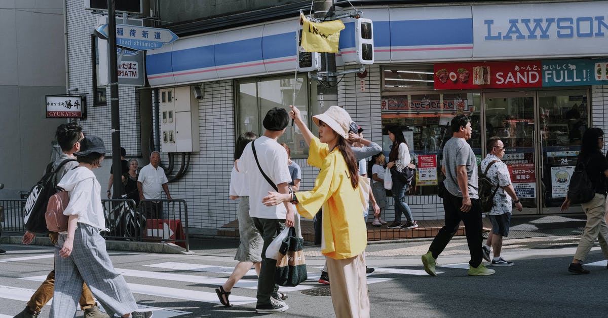 Do I need a Japan visa? [duplicate] - Man in Yellow Dress Shirt and White Pants Walking on Street