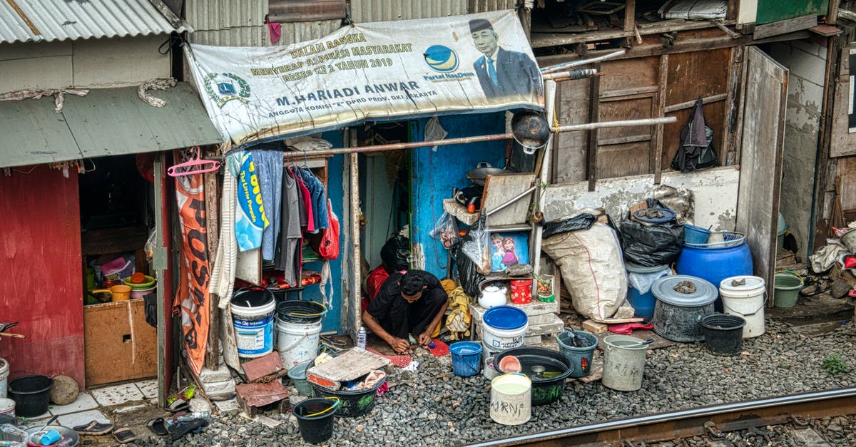 Do I need a Schengen visa from Jamaica? - Unrecognizable man working on street near railway