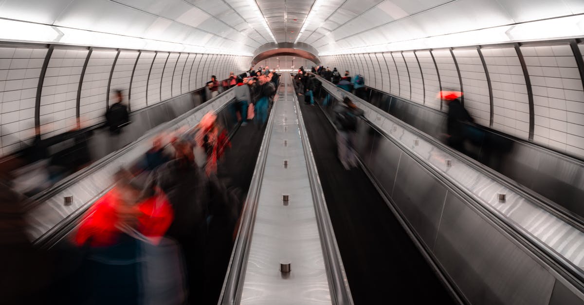 Do I need a transit visa for a trip from Sri Lanka to the British Virgin Islands via Doha, Amsterdam and Sint Marteen? - Anonymous people on escalator in modern subway