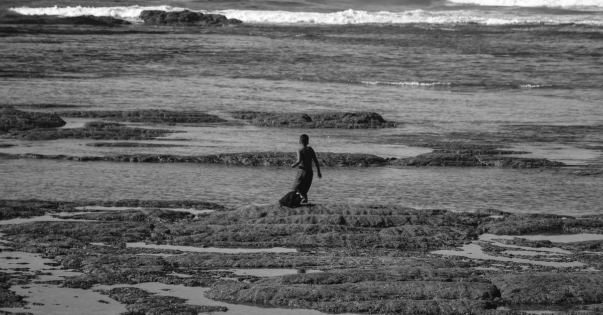 Do I need a transit visa for Morocco (Casablanca) and Guinea-Bissau for a short layover? - Grayscale Photo Of Person Walking On Beach