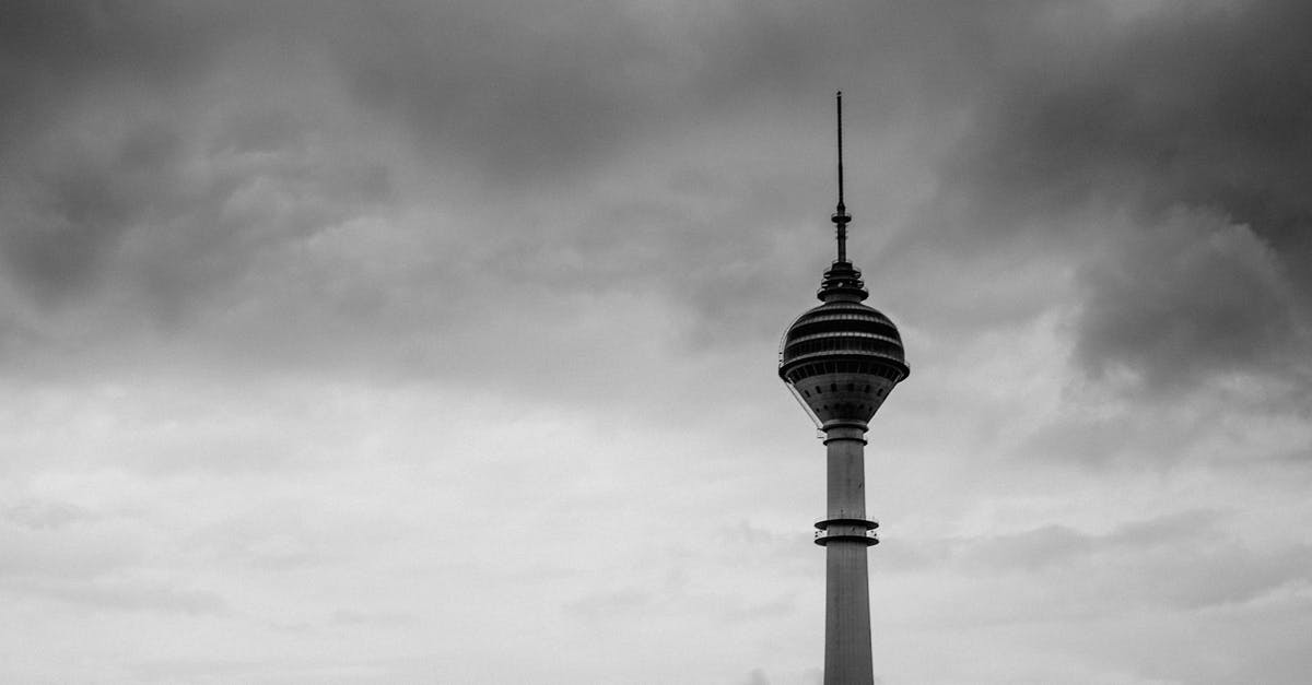 Do I need a transit visa in Kuala Lumpur? - Grayscale Photo of Tower Under Cloudy Sky