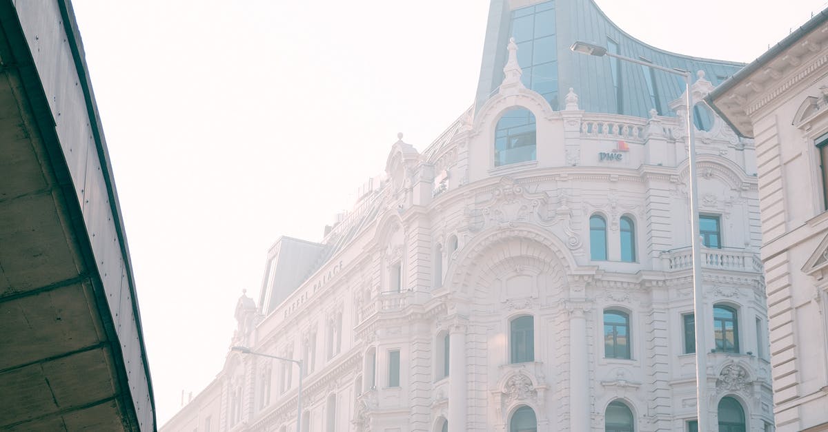 Do I need a visa to travel to Paris from London? - Facade of old elegant building with arched windows and ornamental elements