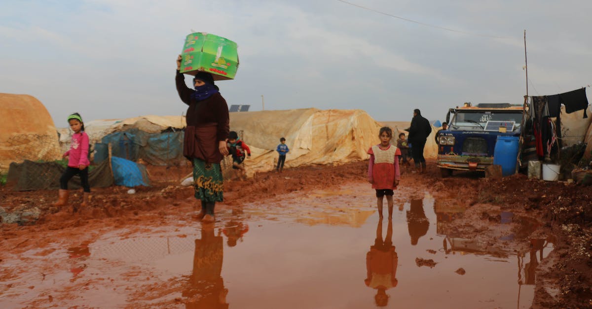 Do I need a visa to walk over the Rainbow bridge? - Ethnic kids and adults walking on dirty road