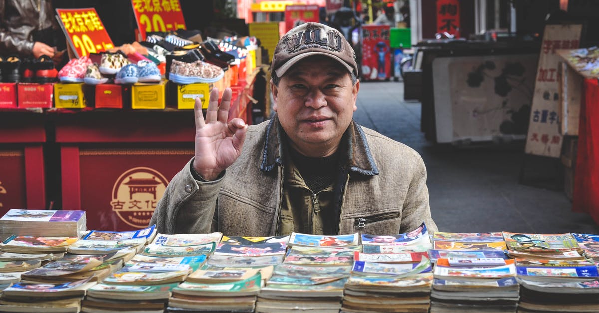 Do I need an old passport to get chinese visa in Hong Kong? - Man in Brown Coat in Front of Books
