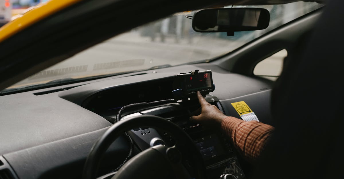 Do I need Korean transit visa - Crop ethnic man with navigator in taxi