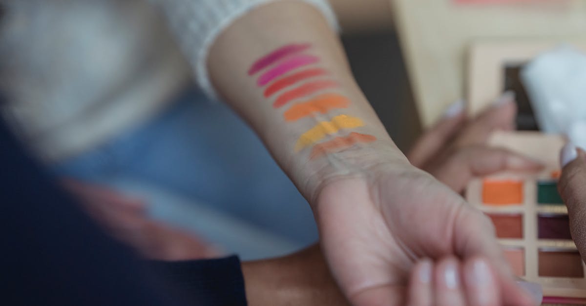 Do I need to apply for a new Schengen visa? - Faceless women applying multicolored eyeshadows on wrist for testing