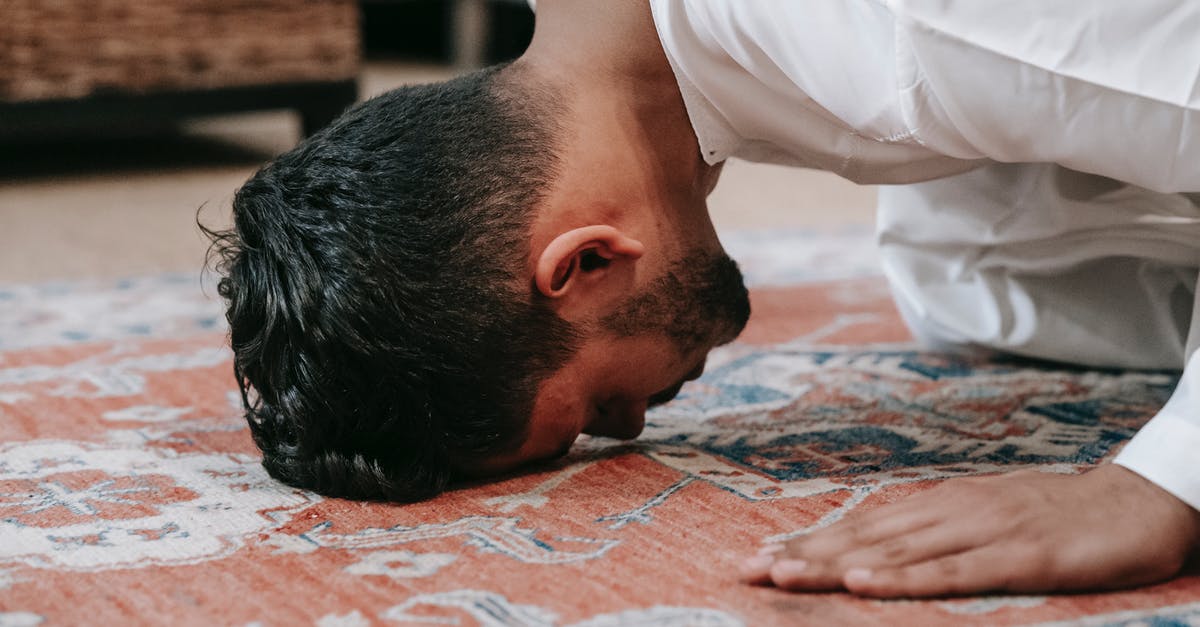 Do i require a transit visa to head through munich? [duplicate] - Man in White Thobe Bowing Down on Red and Blue Rug