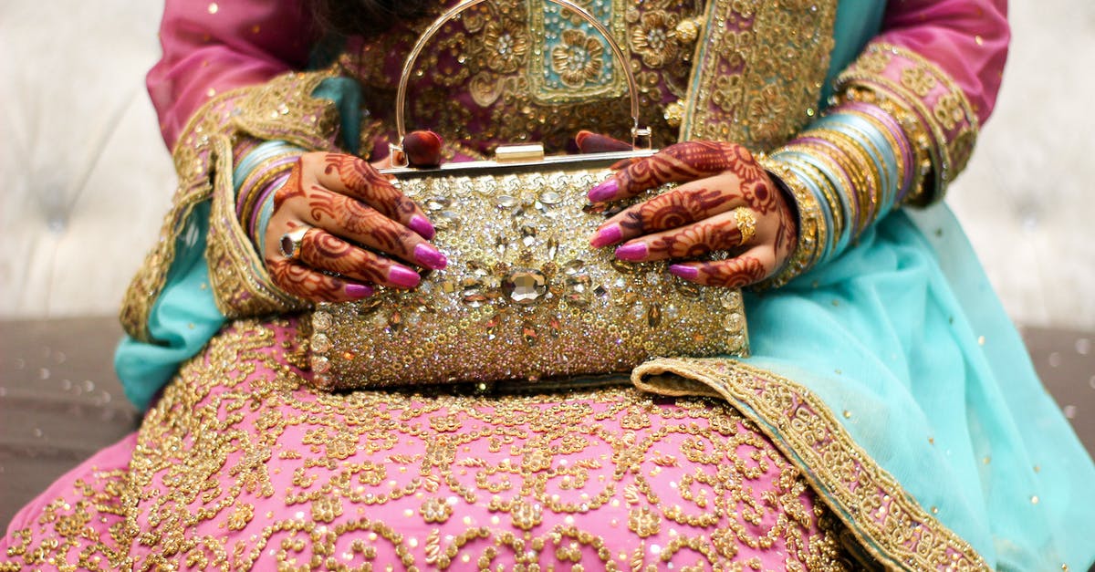 Do Indian citizens need a visa for Okinawa? [closed] - Close-up of a Woman in Traditional Clothing and with Hands Painter with Ornamental Henna Holding a Purse 