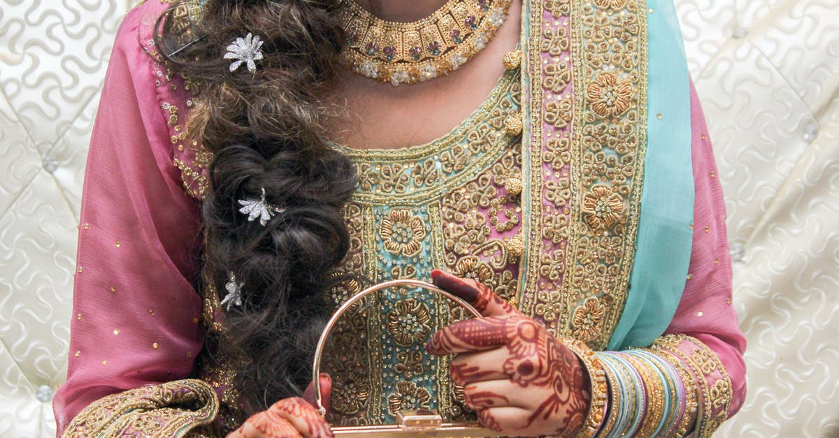 Do Indian citizens need a visa for Okinawa? [closed] - Close-up of a Woman in Traditional Clothing and with Hands Painter with Ornamental Henna Holding a Purse