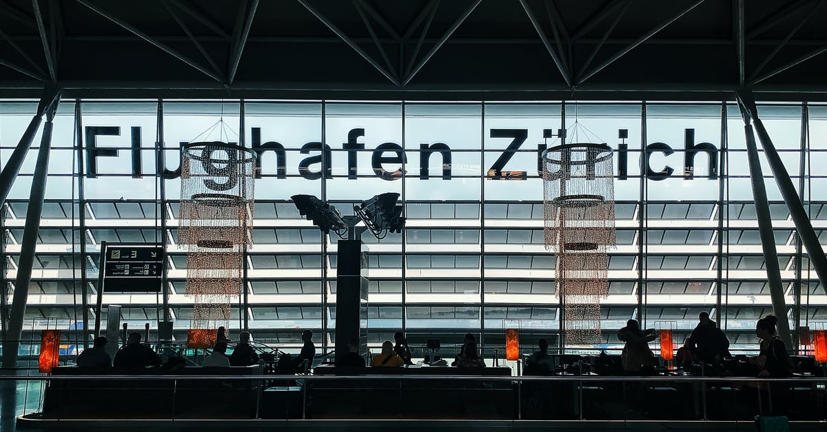 Do intra-Schengen flights into Zurich deplane into the departures concourse? - Silhouette of People Sitting in Airport Waiting Area