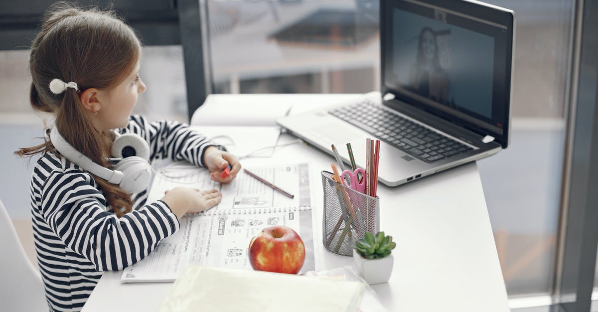 Do l need a room booked before arriving in Vietnam? - Boy in Black and White Striped Long Sleeve Shirt Writing on White Paper