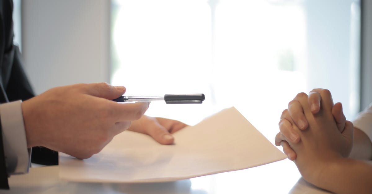 Do most places in Paris accept payments with visa/credit card? - Crop businessman giving contract to woman to sign