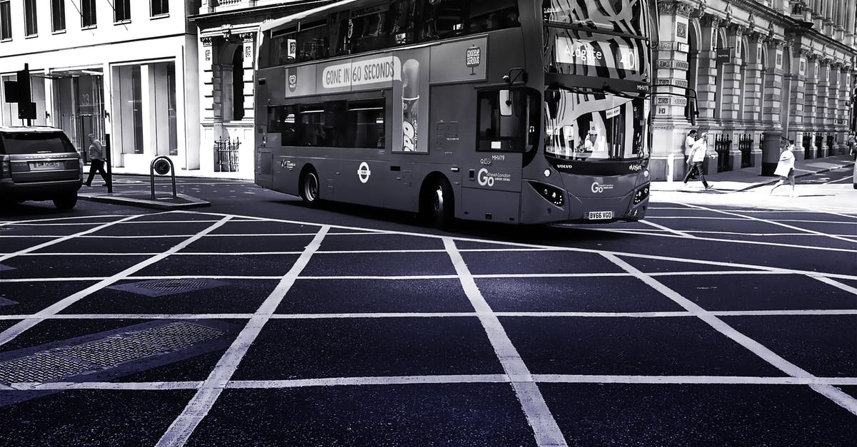 Do pedestrians imitate automotive traffic? - Grayscale Photo of Double Decker Bus on Road