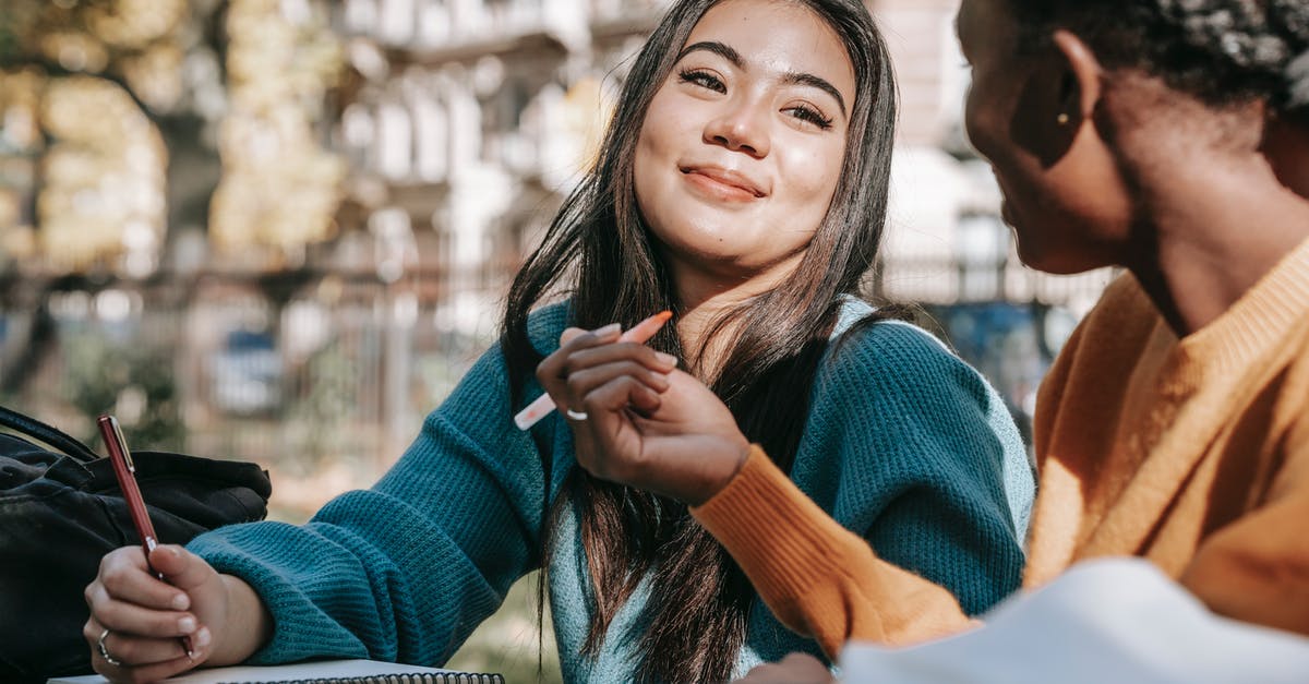 Do Russians smile at each other? - Glad diverse students taking notes while working on project