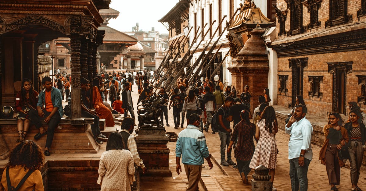 Do stores at tourist-heavy sites in Nepal accept USD? - People Standing Near Building