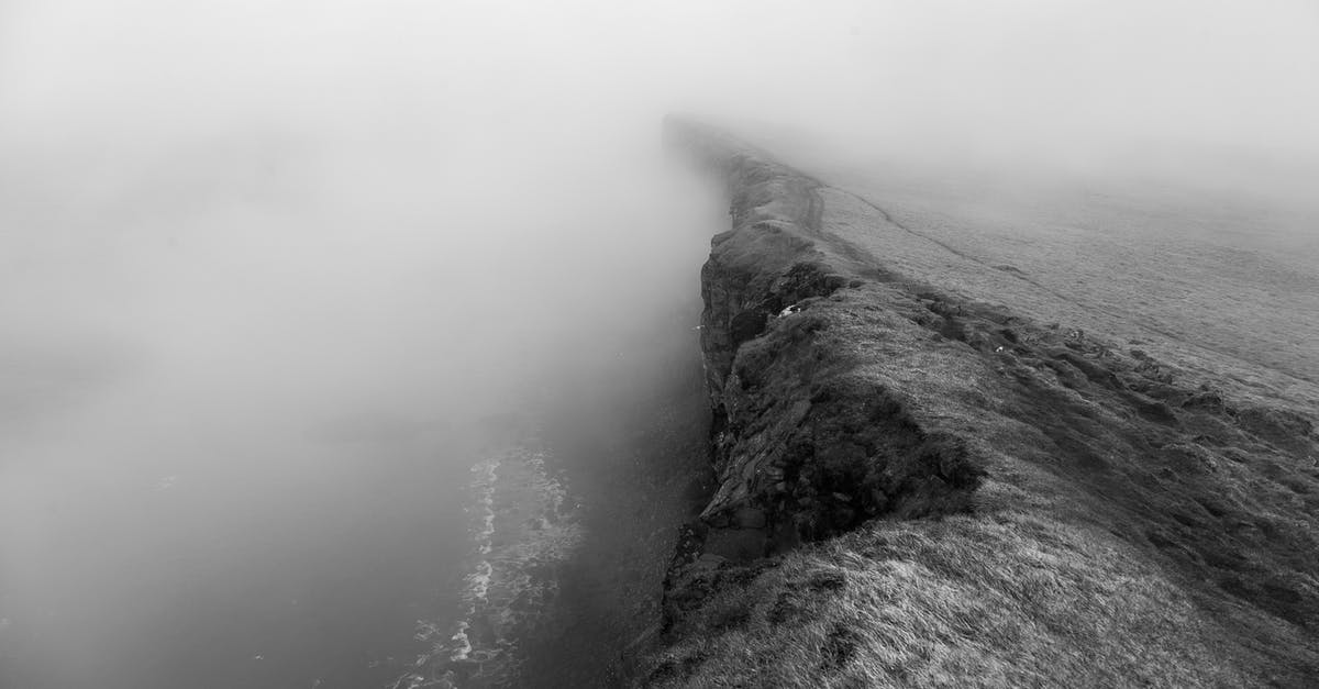 Do the Canary Islands always have high waves? - Grayscale Photo of Cliff Near Body of Water