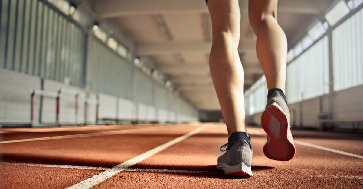 Do the Chinese CRH trains have power outlets? - From below back view of crop strong runner walking along running track in athletics arena while doing warm up exercises during workout