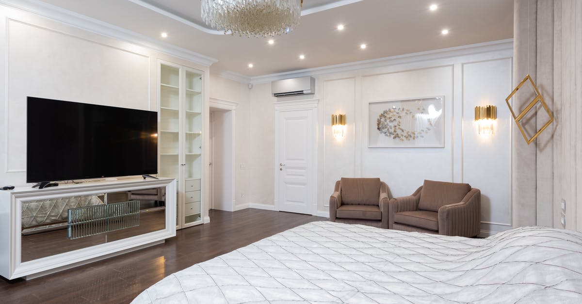 Do the new Canadian hotel quarantine requirements apply to non-residents? - Interior of spacious classic styled bedroom decorated with golden chandelier and lamps