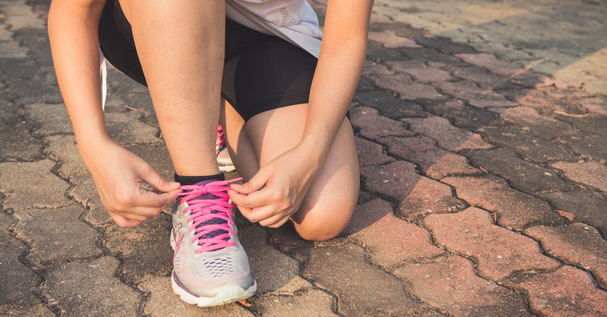 Do trains run to Beni Nsar Port in Morocco? - Woman Lacing Up Her Gray and Pink Nike Low-top Athletic Shoe