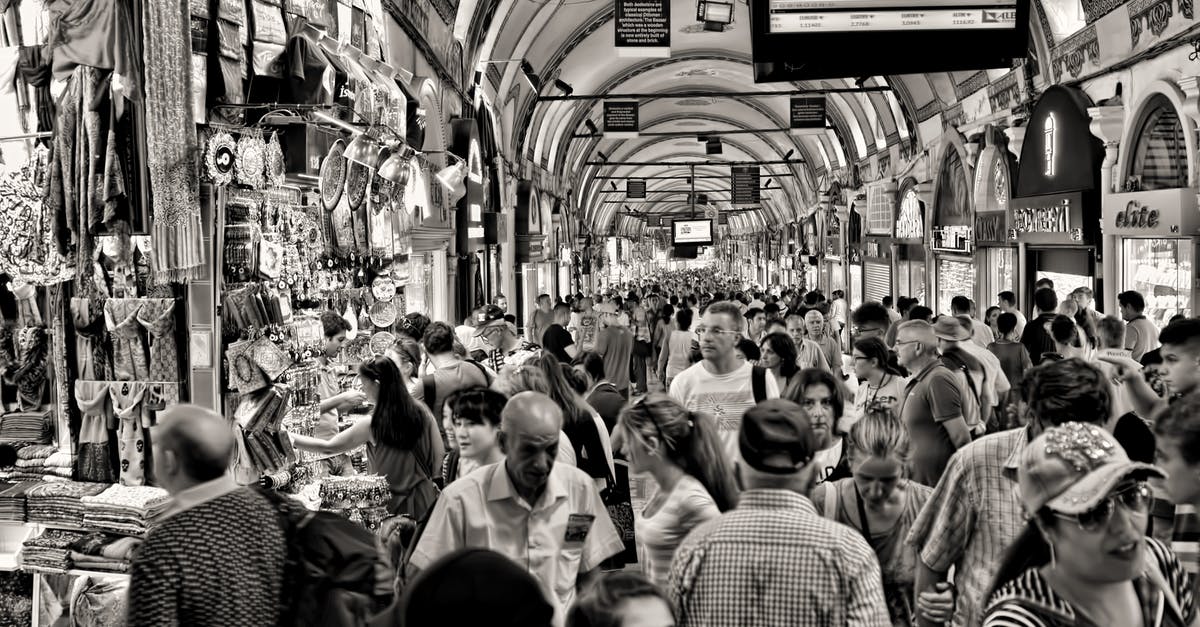 Do Varadero or Havana airports have shops which sell cigars and alcohol? - Grayscale Photo of People at Market