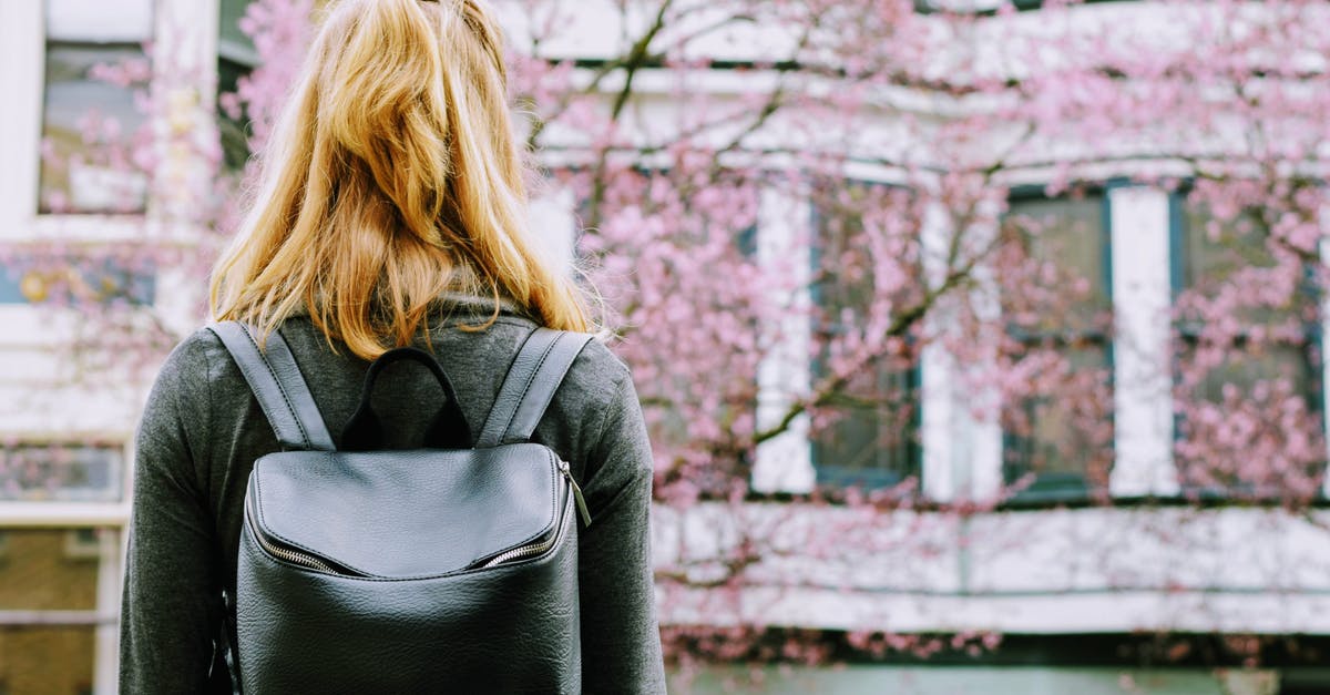 Do we need a transit visa for Japan if re-checking bags? - Woman Wearing Backpack Standing in Front Building Do we need a transit visa for Japan if re-checking bags? - Woman Wearing Backpack Standing in Front Building