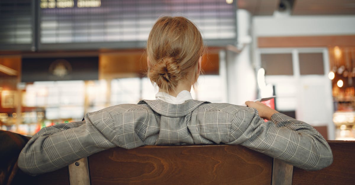 Do we need an airport transit visa to wait in 3 different airports in Europe, if the final destination is Brazil? - Back view of female employee in trendy jacket waiting for train departure and leaning on backs of wooden seats in train station Do we need an airport transit visa to wait in 3 different airports in Europe, if the final destination is Brazil? - Back view of female employee in trendy jacket waiting for train departure and leaning on backs of wooden seats in train station