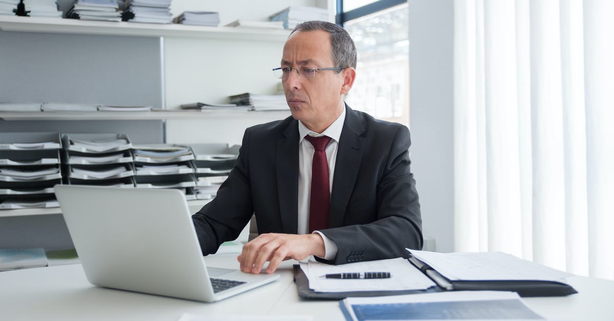 Documents for UK standard visit visa (academic purposes) - Man in Black Suit Jacket Using Macbook Air