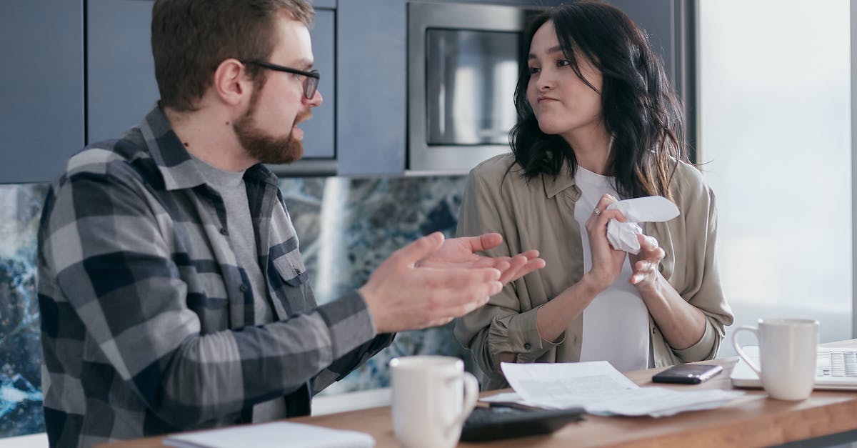 Documents required for sponsoring girlfriend for Schengen visa? - A Woman Looking at Her Partner while Crumpling a Paper