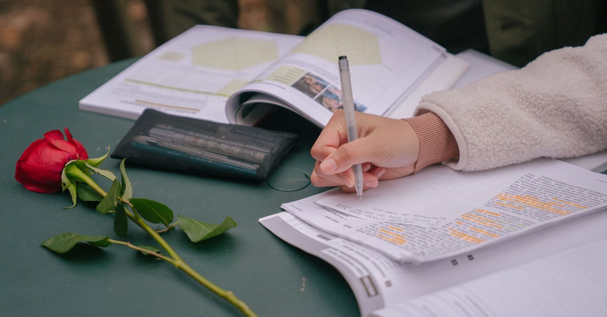 Documents required for sponsoring girlfriend for Schengen visa? - Faceless couple studying with textbooks while writing information on paper