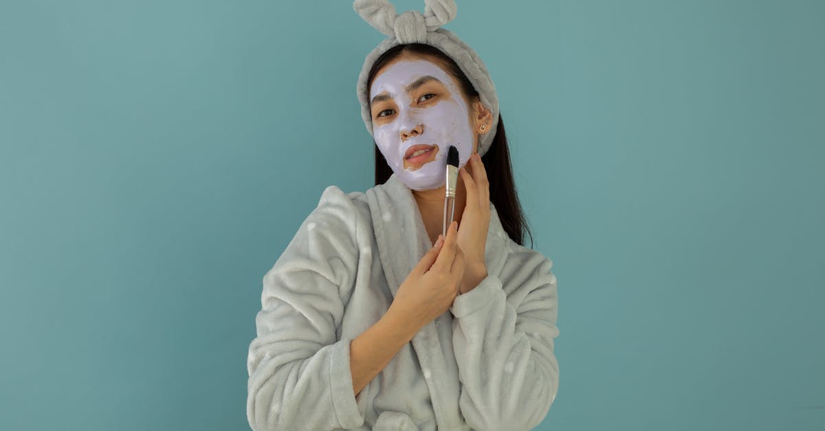 Does 24-hour grace period apply after paid changes to airline reservations? - Young ethnic female in robe and headband applying cleansing mask with cosmetic brush while looking at camera on turquoise background